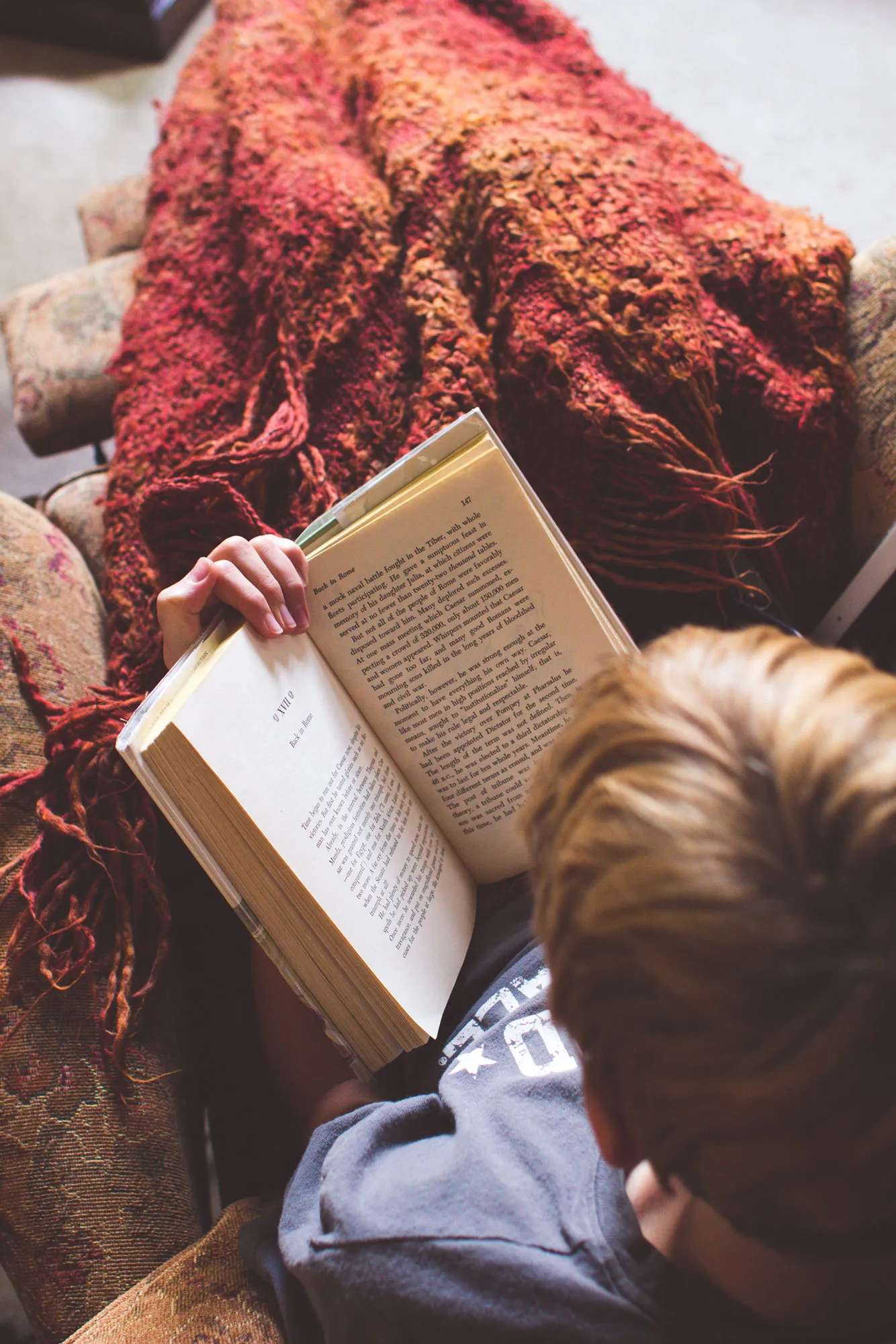 A photo of someone cozied up and reading