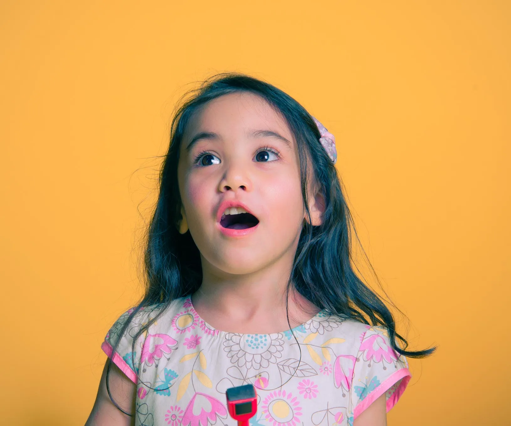 A young girl with a surprised expression